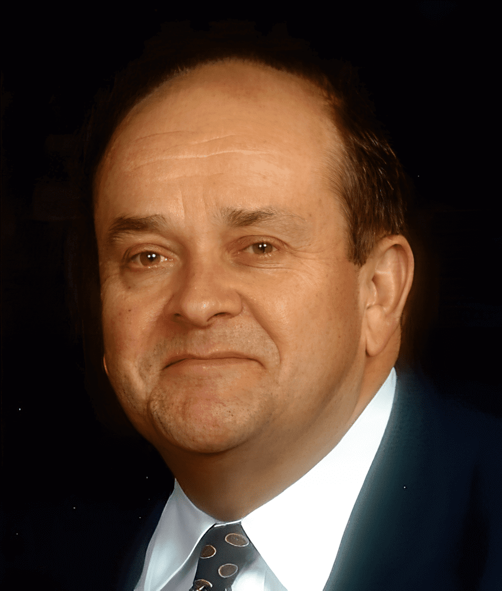 Man in suit with patterned tie.